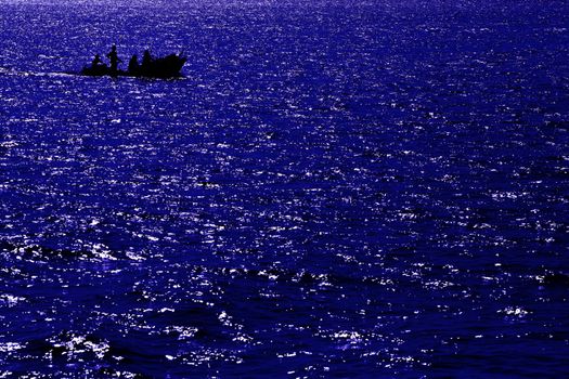 Abstract deep blue sea with Silhouettes boat