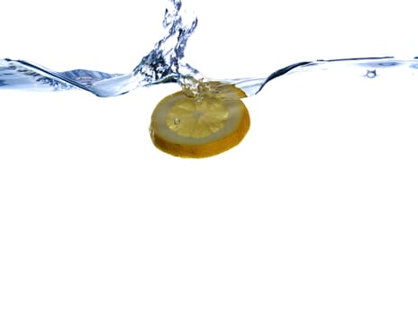 Lemon in the flight surrounded and followed by water bubbles