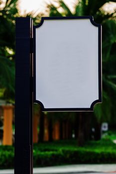 White Blank sign board with blue pole in green park