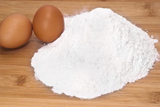 Eggs and flour. preparation of pasta on wooden table