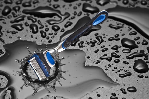 shaving razor falls inside a drop of water