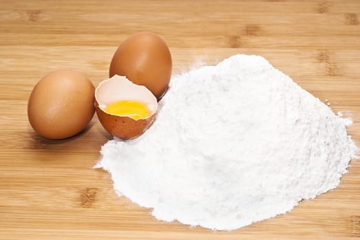 Eggs and flour. preparation of pasta on wooden table