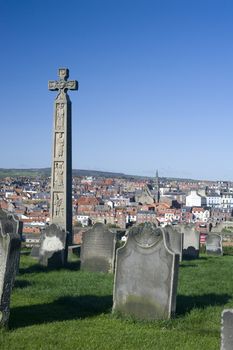 Caedmons Cross, an ornately carved and inscribed stone celtic cross commemorating, Caedmon, an Anglo-Saxon, poet and songwriter, in St Marys Graveyard in Whitby