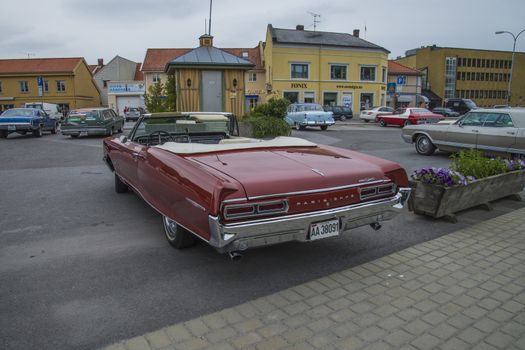 The image is shot at a fish-market in Halden, Norway where there every Wednesday during the summer months are held classic American car show.