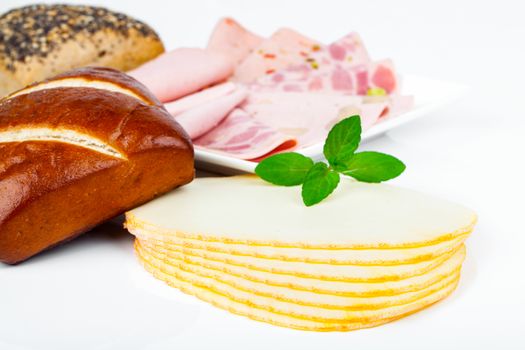 Cheese slices, sausage and bun  for breakfast, isolated on white background
