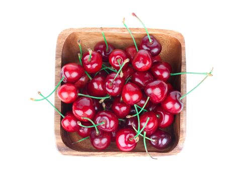 cherry berry in wooden bowl, isolated on white background