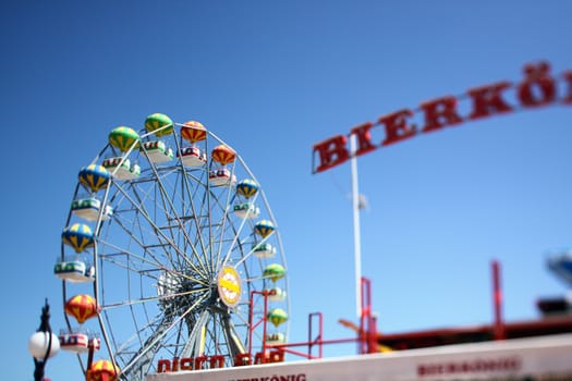 Ferris Wheel at amusement park. Photo taken with tilt- shift lens, shallow dof