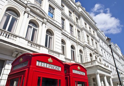 Iconic red Telephone Boxes outside attractive London appartments.