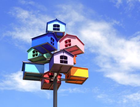 Colorful nesting boxes on blue sky