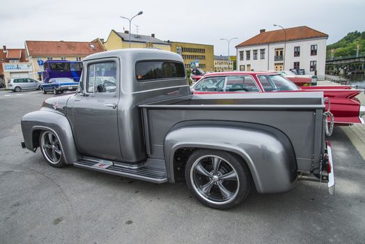 The image is shot at a fish-market in Halden, Norway where there every Wednesday during the summer months are held classic American car show.