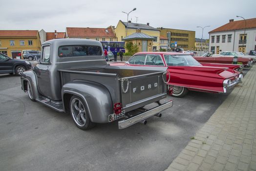 The image is shot at a fish-market in Halden, Norway where there every Wednesday during the summer months are held classic American car show.