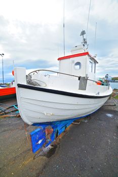 Fishing boats repair in the harbor of Husavik, Iceland