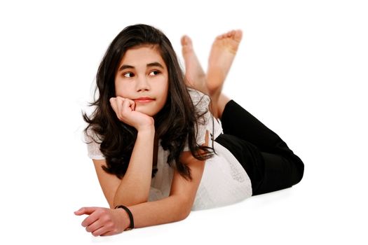 Beautiful biracial teen girl lying on floor relaxing, bored