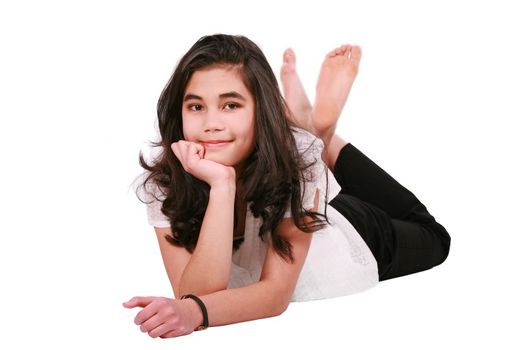 Beautiful biracial teen girl lying on floor relaxing, feet crossed