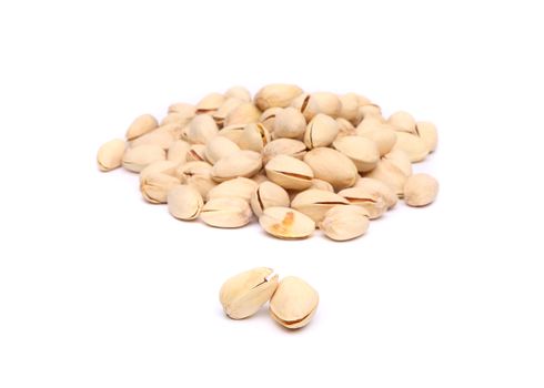 Two pistachios and hill of pistachios on the white background.