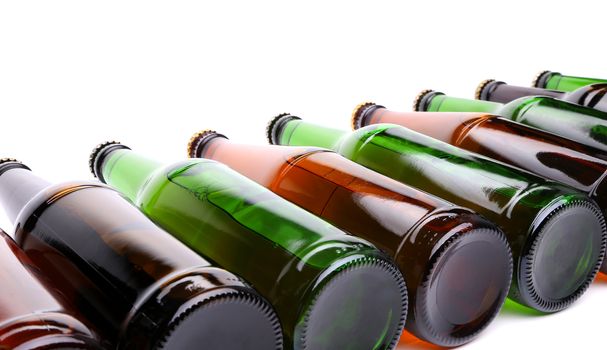 Different bottles of beer are located on the white background.