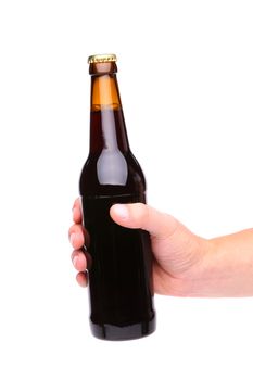 A hand holding up a brown beer bottle without label over a white background vertical format