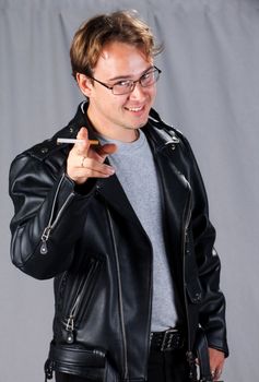 young smiling man in leather Jacket with cigarette