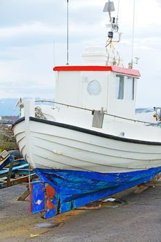 Fishing boats repair in the harbor of Husavik, Iceland