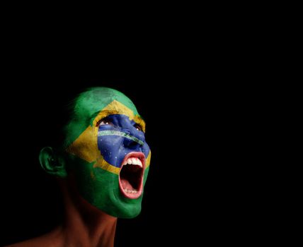 The Brazilian flag on the face of a screaming woman. concept