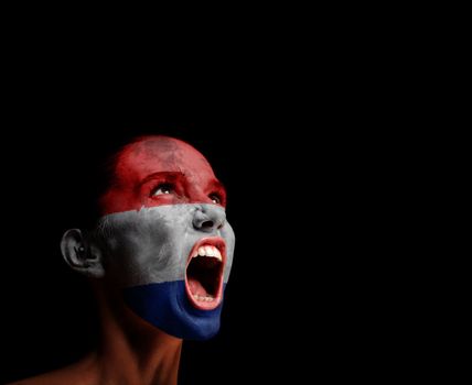 The Netherlands flag on the face of a screaming woman. concept