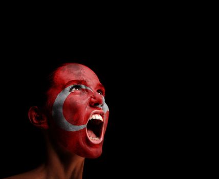 The Turkish flag on the face of a screaming woman. concept