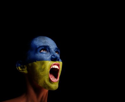 The Ukrainian flag on the face of a screaming woman. concept