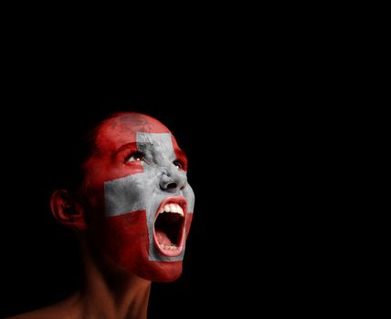 The Swiss flag on the face of a screaming woman. concept