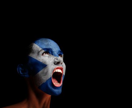 The Scotland flag on the face of a screaming woman. concept