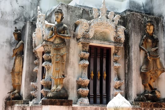 Buddha sculptures in an ancient buddhist wat in Thailand