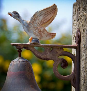 rusty bell with duck in Asturias, Spain