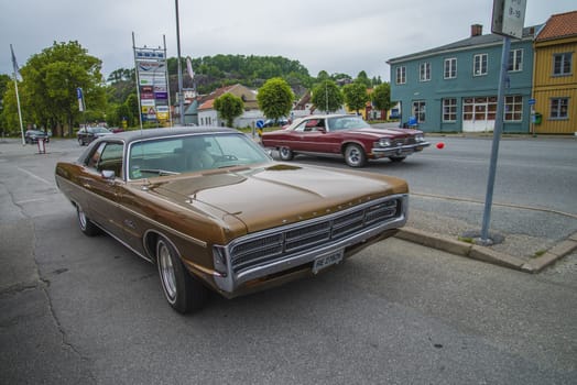 The image is shot at a fish-market in Halden, Norway where there every Wednesday during the summer months are held classic American car show.