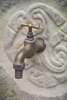 tap on stone wall in Asturias, Spain