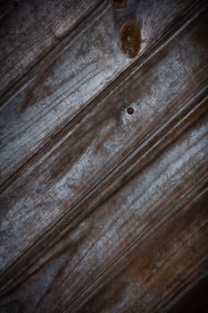 Old wooden door with rusty nail