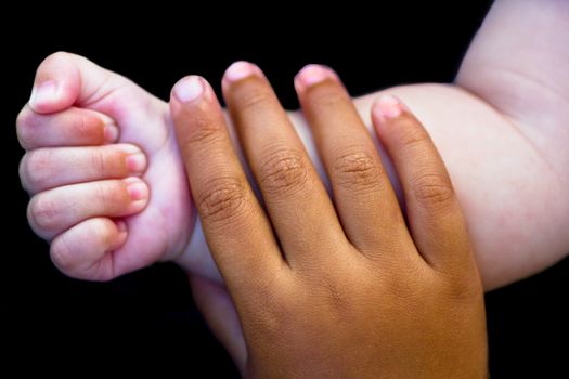 two child hands isolated on black