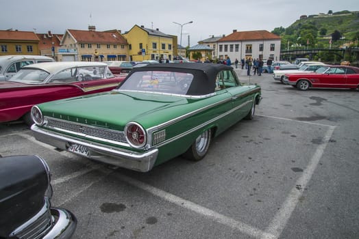 The image is shot at a fish-market in Halden, Norway where there every Wednesday during the summer months are held classic American car show.