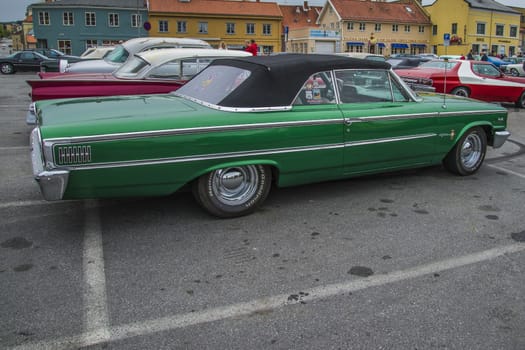 The image is shot at a fish-market in Halden, Norway where there every Wednesday during the summer months are held classic American car show.