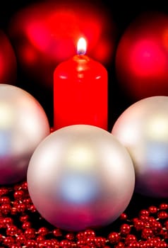 christmas composition with candle and balls