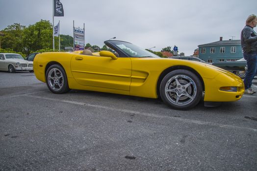 The image is shot at a fish-market in Halden, Norway where there every Wednesday during the summer months are held classic American car show.