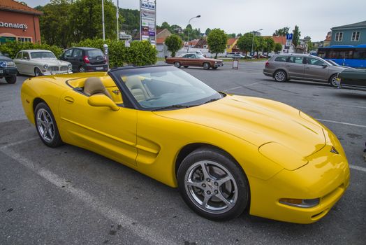 The image is shot at a fish-market in Halden, Norway where there every Wednesday during the summer months are held classic American car show.