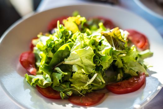 mediterranean green salad and fresh tomatoes with balsamic vinegar