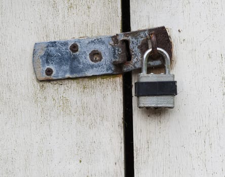 close up of a padlock on wooden doors