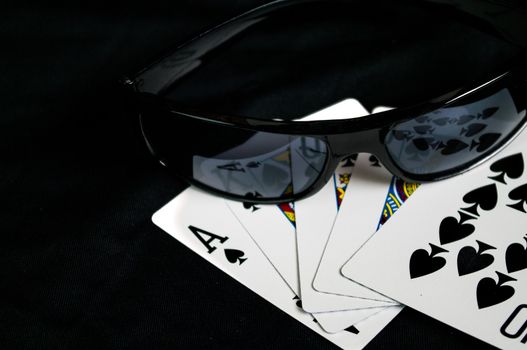 Playing Cards and glasses  with a Royal straight flush