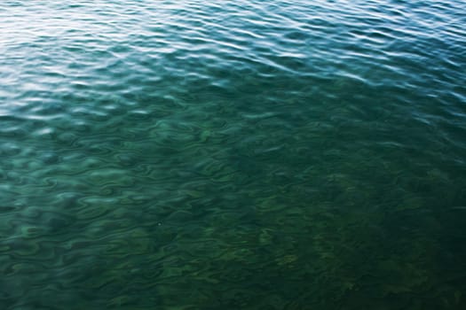 green waves on the lake on summer as texture