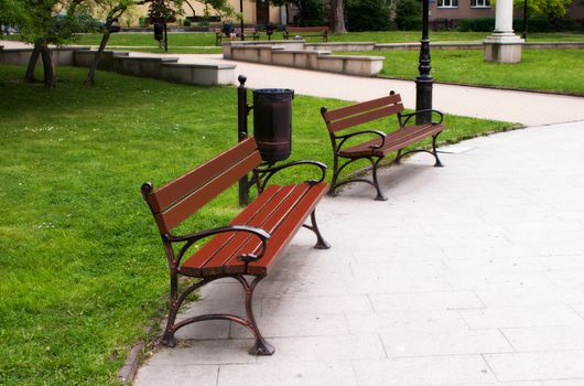 two benches in the city park on summer day