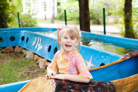 child in the boat in the amusement park