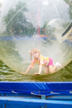 happy child in the ball in water