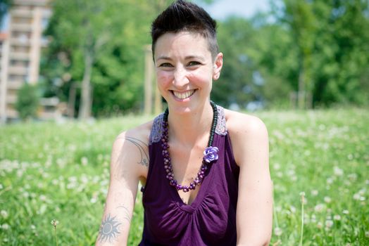 beautiful hipster short hair woman in the park in the city