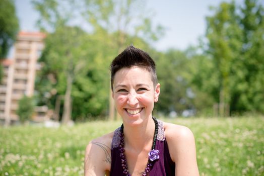 beautiful hipster short hair woman in the park in the city