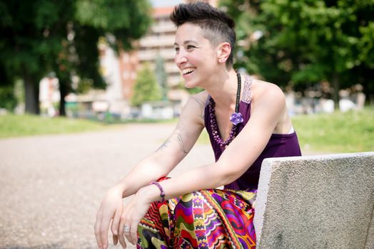 beautiful hipster short hair woman in the park in the city